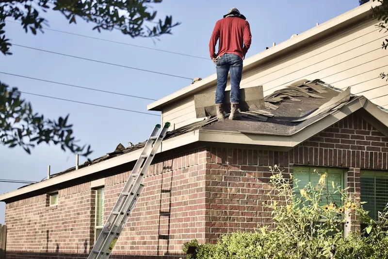 Professional roofer working on a residential roof in Fridley